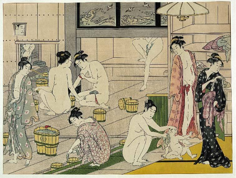 women and kids taking path in public bathhouse