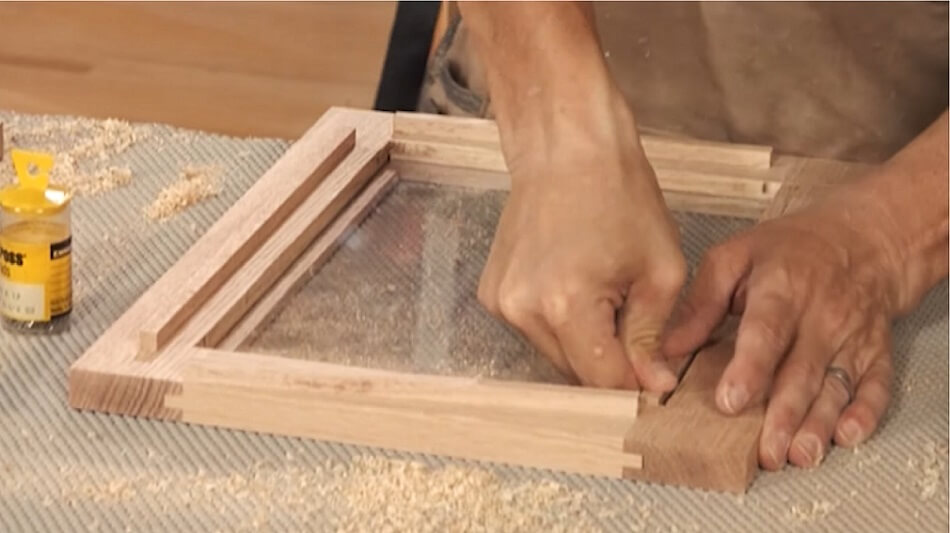 carpenter making inset door