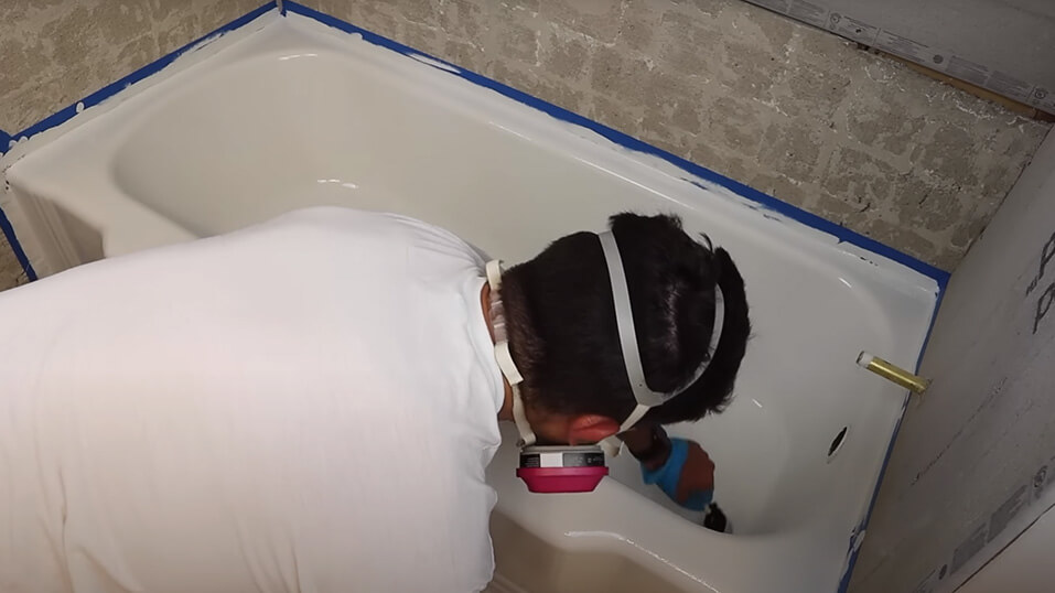 Man Applying the Paint Layer in tub