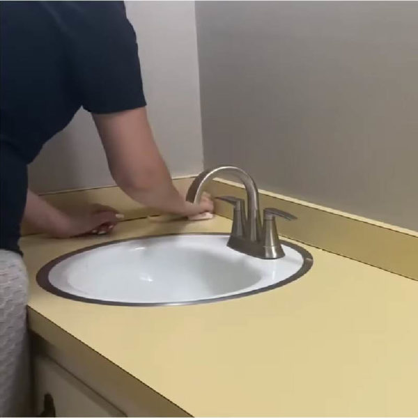 women washing Bathroom Countertops