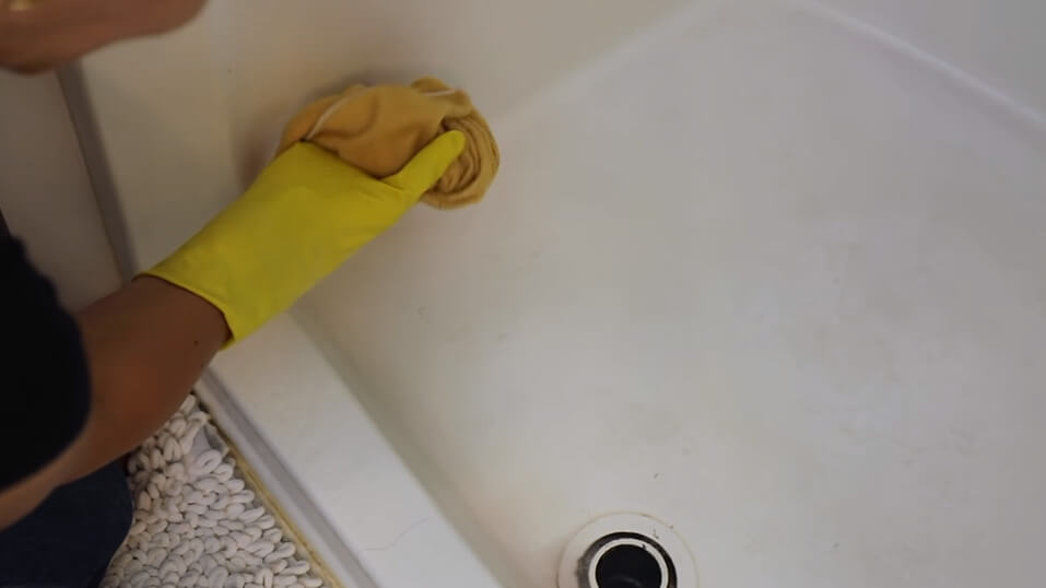 Girl Cleaning bathtub with Liquid cleaner