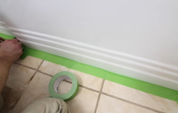 applying paint tape on bathtub
